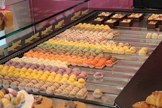 Colorful macarons displayed in a pastry shop.