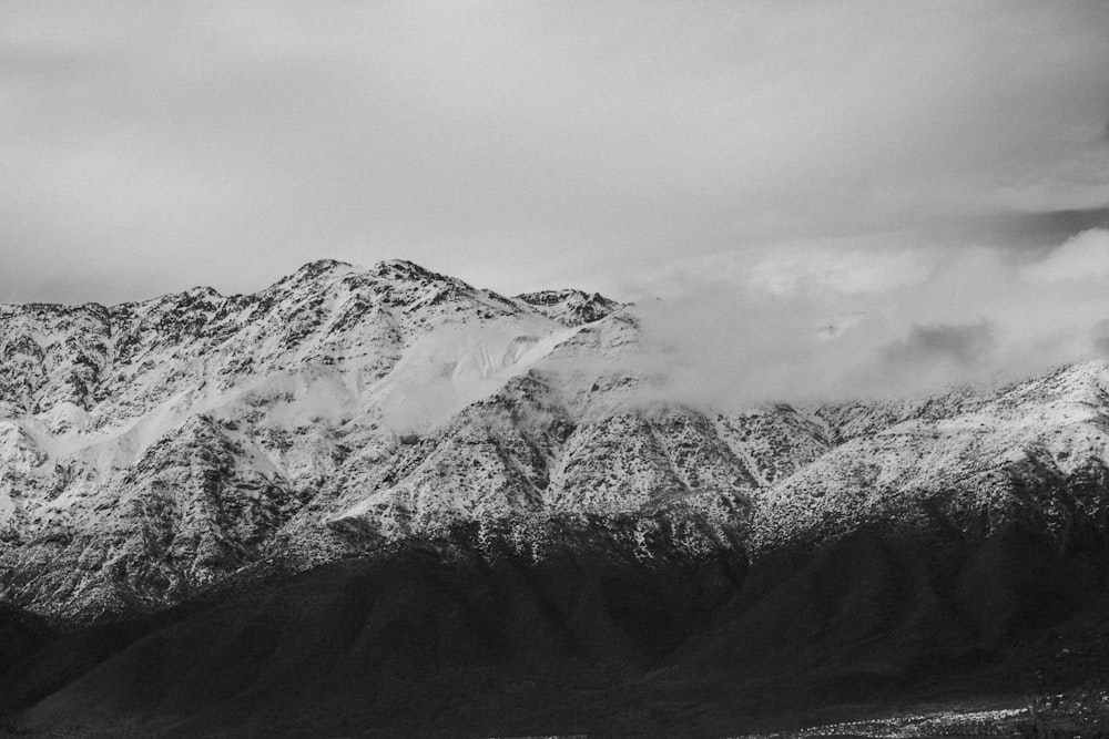 snow covered mountain under cloudy sky during daytime