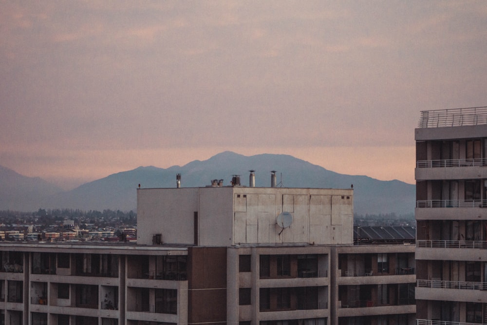 white concrete building near mountain during daytime