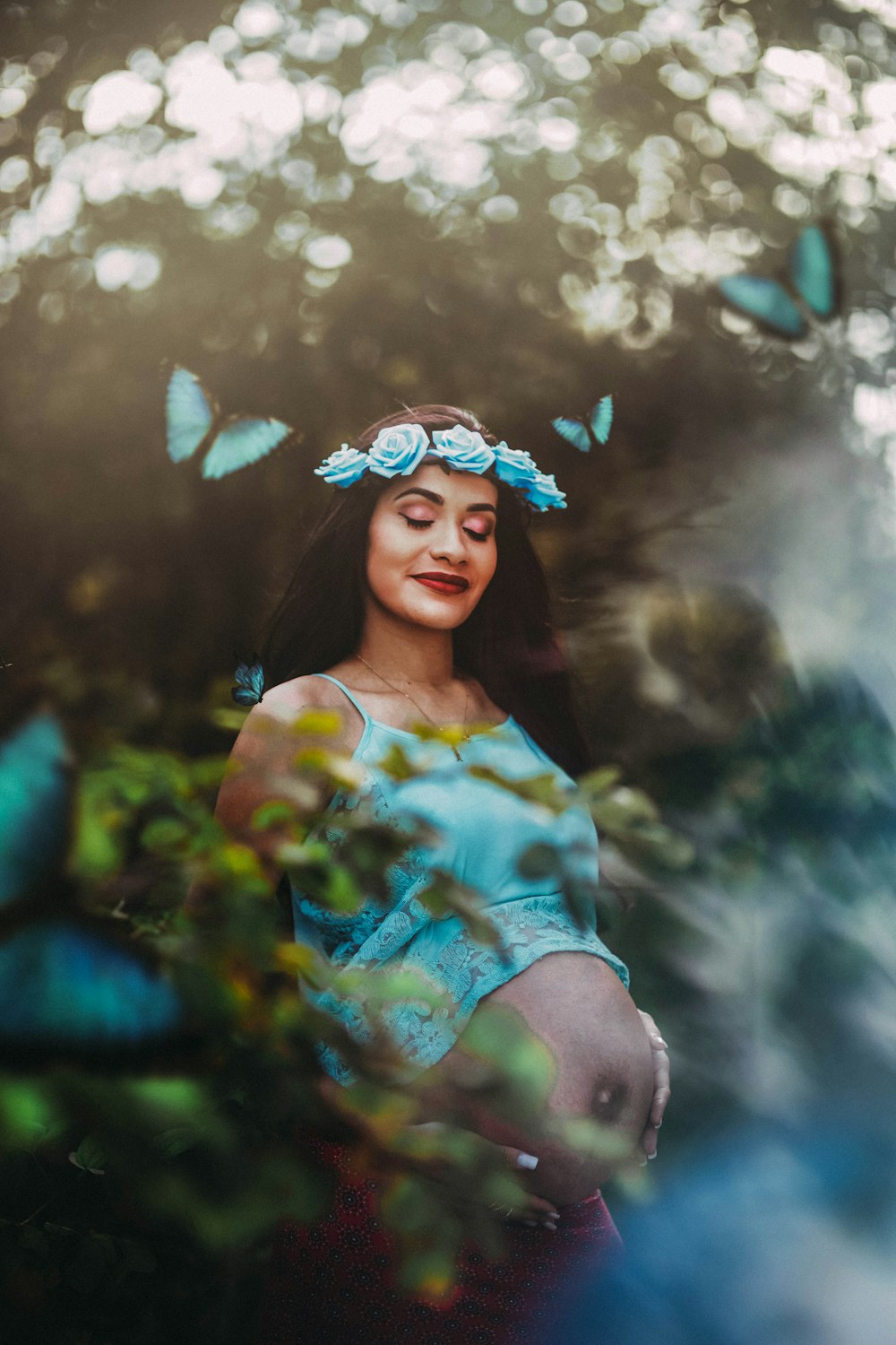 girl in yellow and green floral dress with blue flower crown