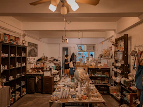 A cozy miniature room bathed in warm light, filled with tiny books and trinkets.