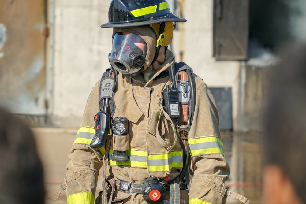 man in green and brown camouflage jacket wearing gas mask