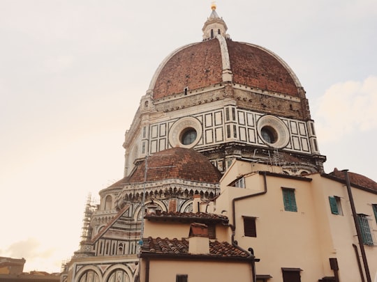 brown and white concrete building in Museum of Opera of Saint Maria of Fiore Italy