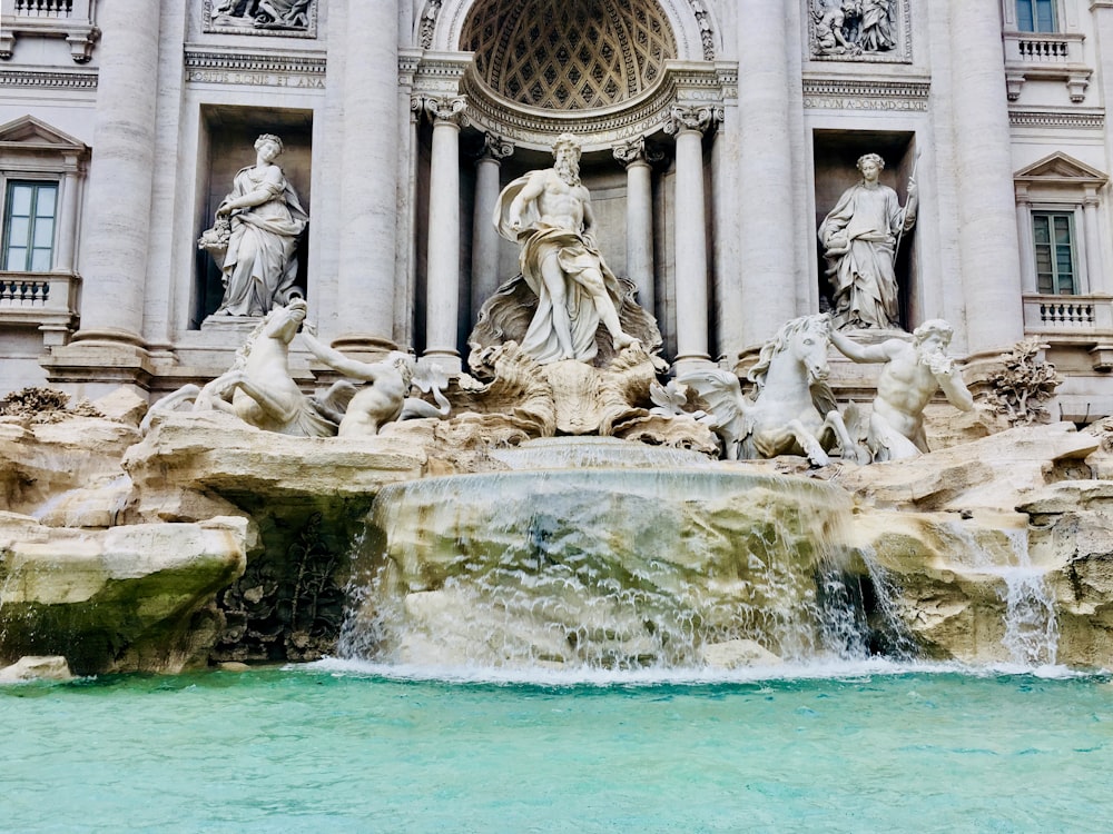 gray concrete statue on water fountain