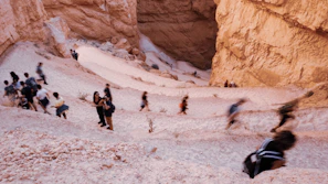 Group hiking through rocky desert landscapes with Marrakech in the distance