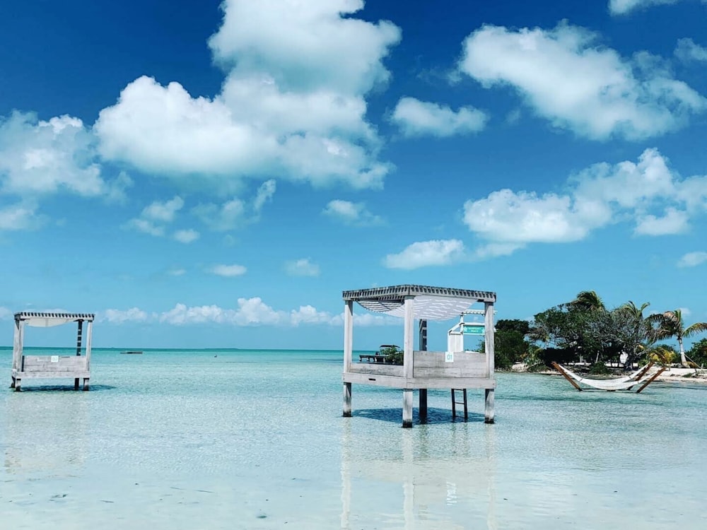 white wooden gazebo on beach during daytime