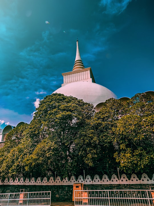 white concrete building near green trees under blue sky during daytime in Kalutara Sri Lanka