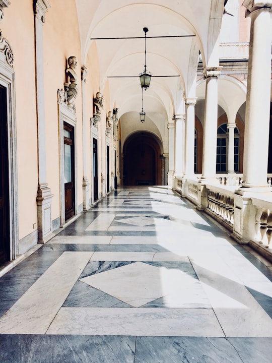 white and gray concrete building in Genoa Italy