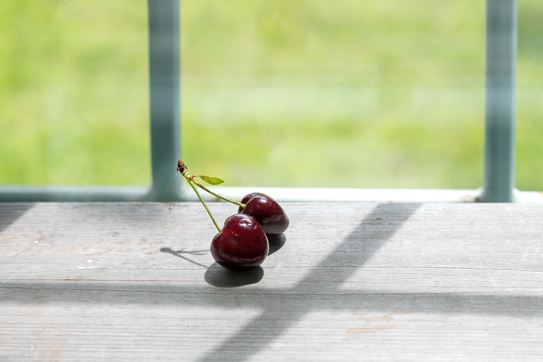 red cherries on white wooden table