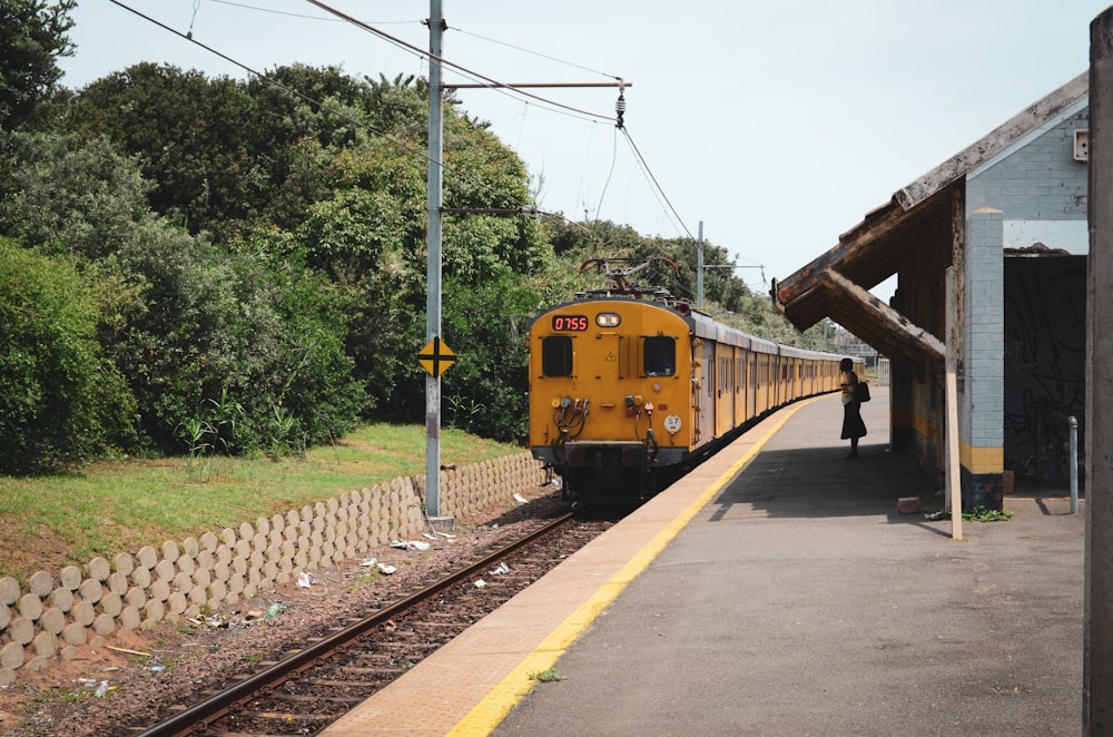 yellow train on rail road during daytime