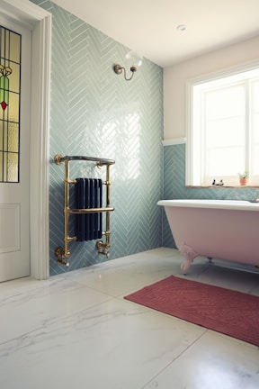 white ceramic bathtub near white bathtub