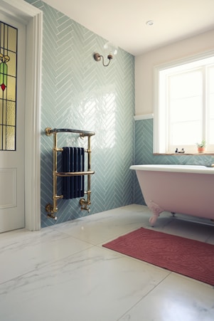 white ceramic bathtub near white bathtub