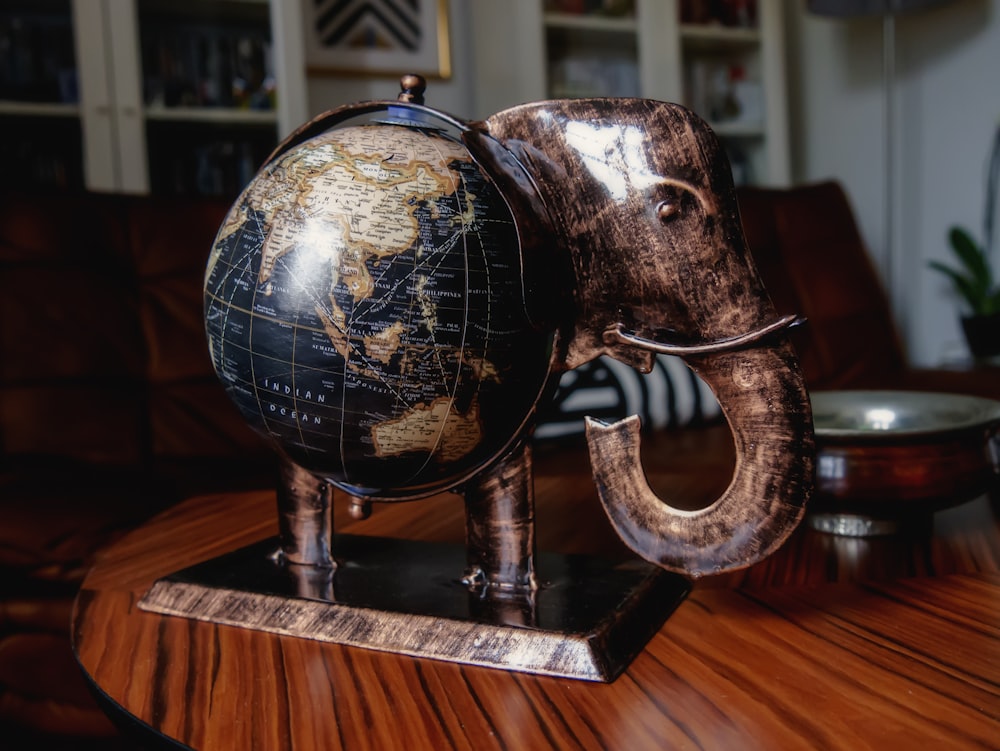 brown wooden elephant figurine on brown wooden table