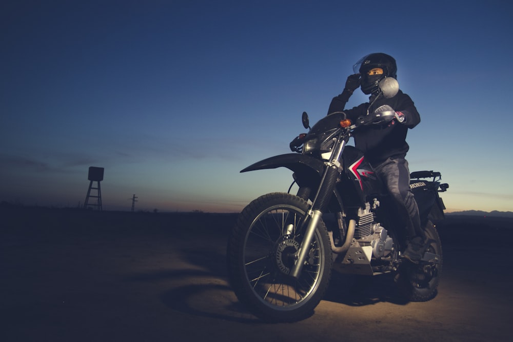 man in black jacket riding black motorcycle
