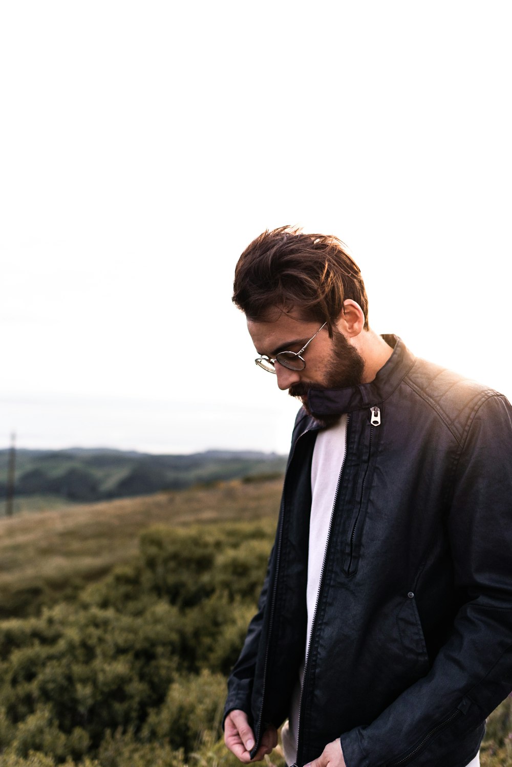 man in black jacket wearing black sunglasses