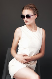 man in white tank top wearing black sunglasses