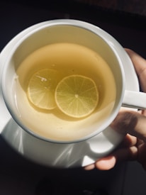 white ceramic mug with yellow liquid