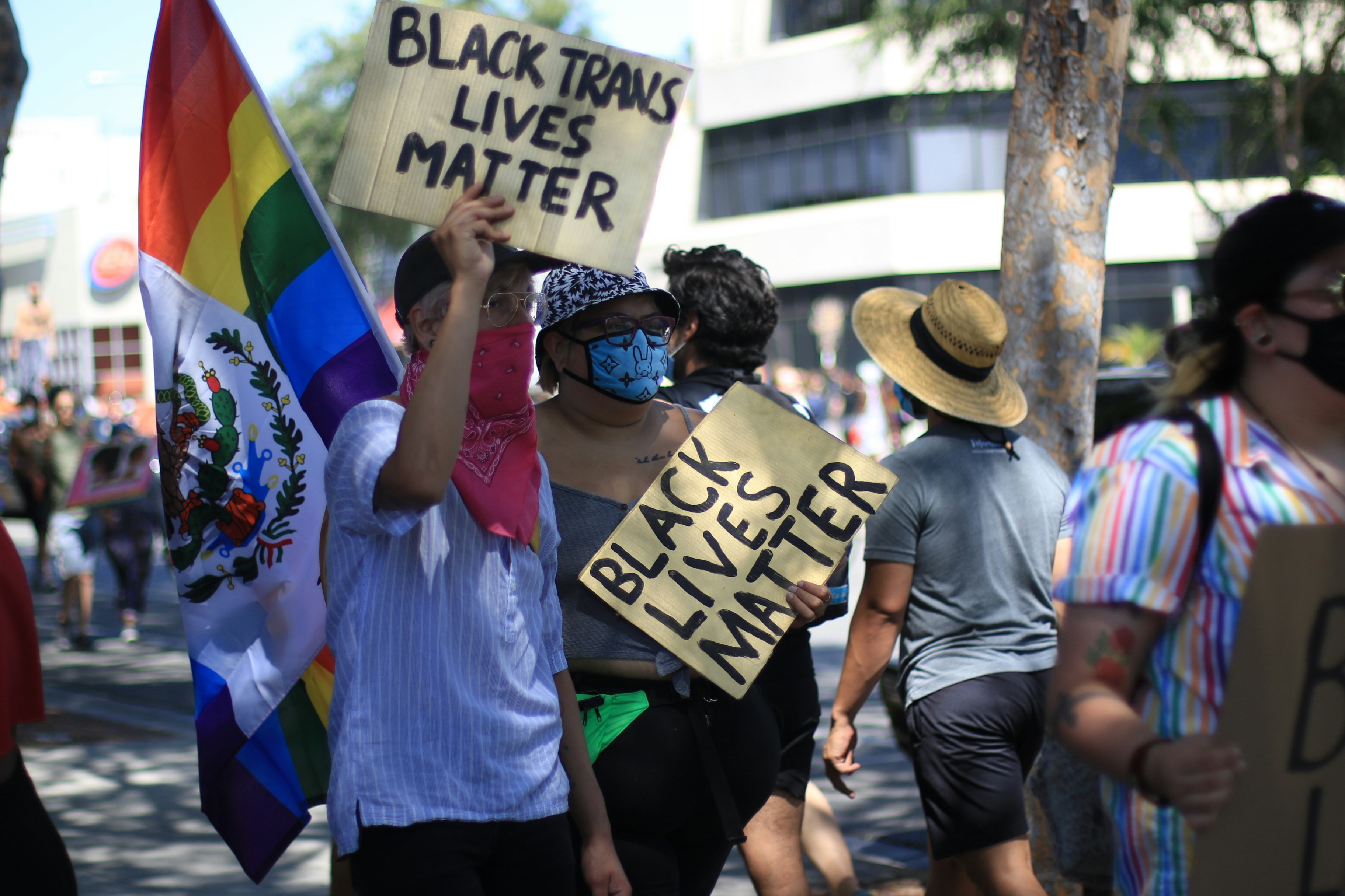 people holding white and black signage during daytime