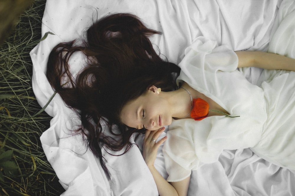 woman in white button up shirt lying on bed