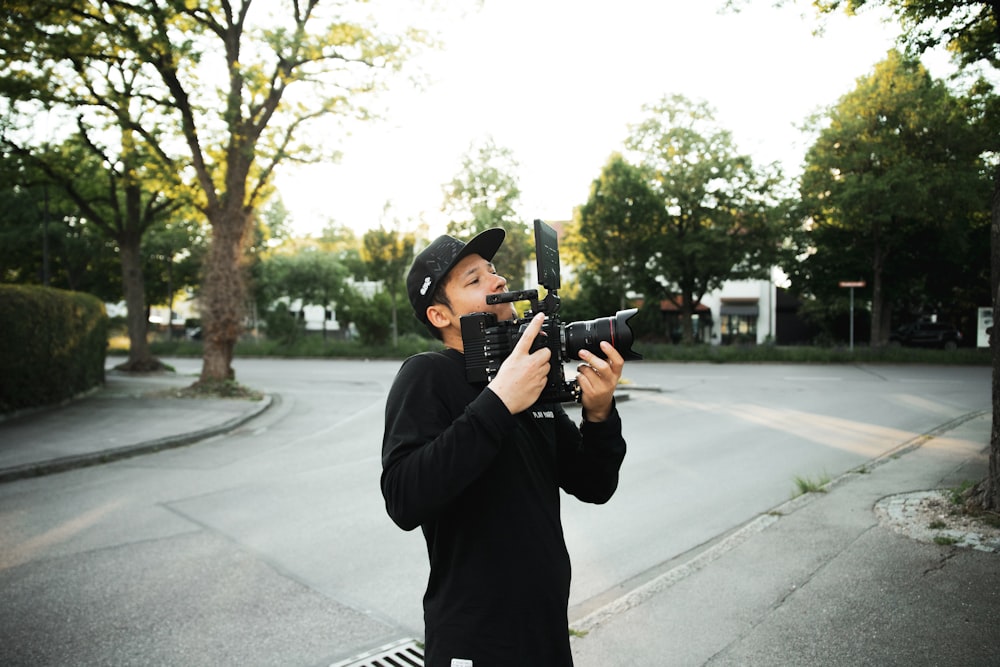 man in black jacket holding smartphone