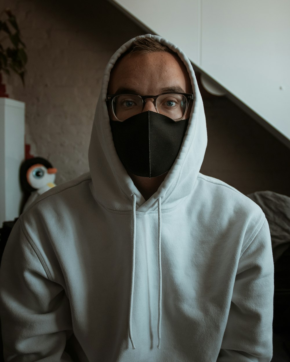 man in white hoodie wearing black frame eyeglasses