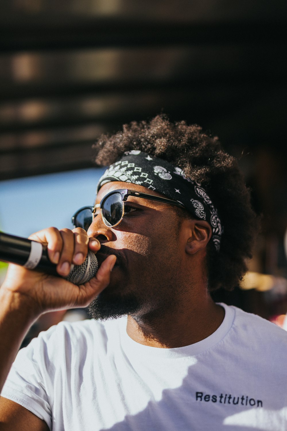 man in white crew neck shirt wearing black sunglasses