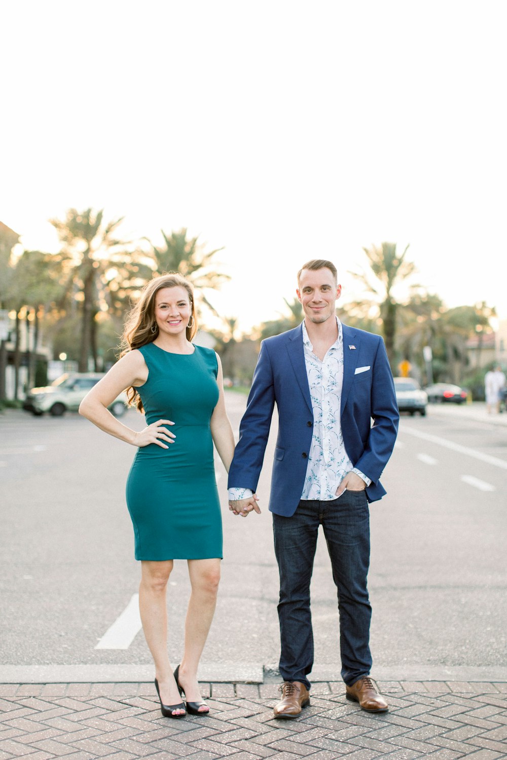 man in blue suit standing beside woman in green dress