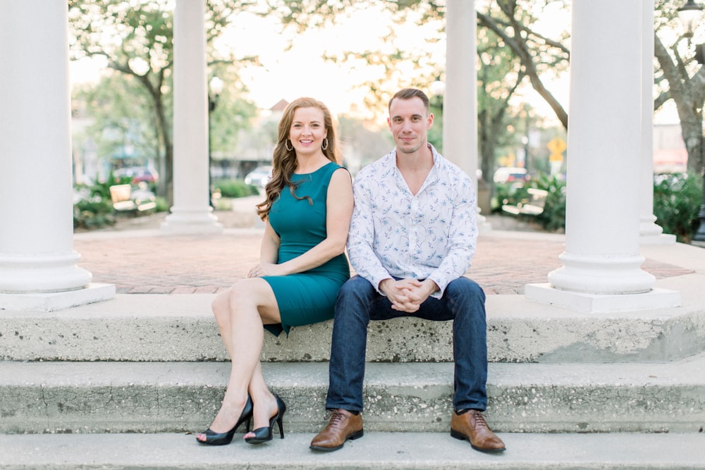 2 women sitting on concrete bench during daytime