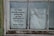 Two paper notices are taped to a window. The one on the left promotes the 1st free black school building in the Northwest Territory, noting an open house event on the third Sunday in September. The notice on the right lists contact information for arranging visits at other times, including names and phone numbers.