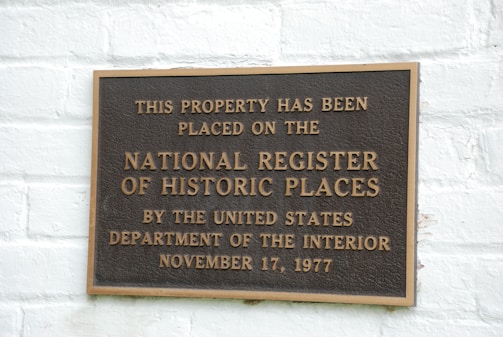 A historical plaque commemorating the house's significance.