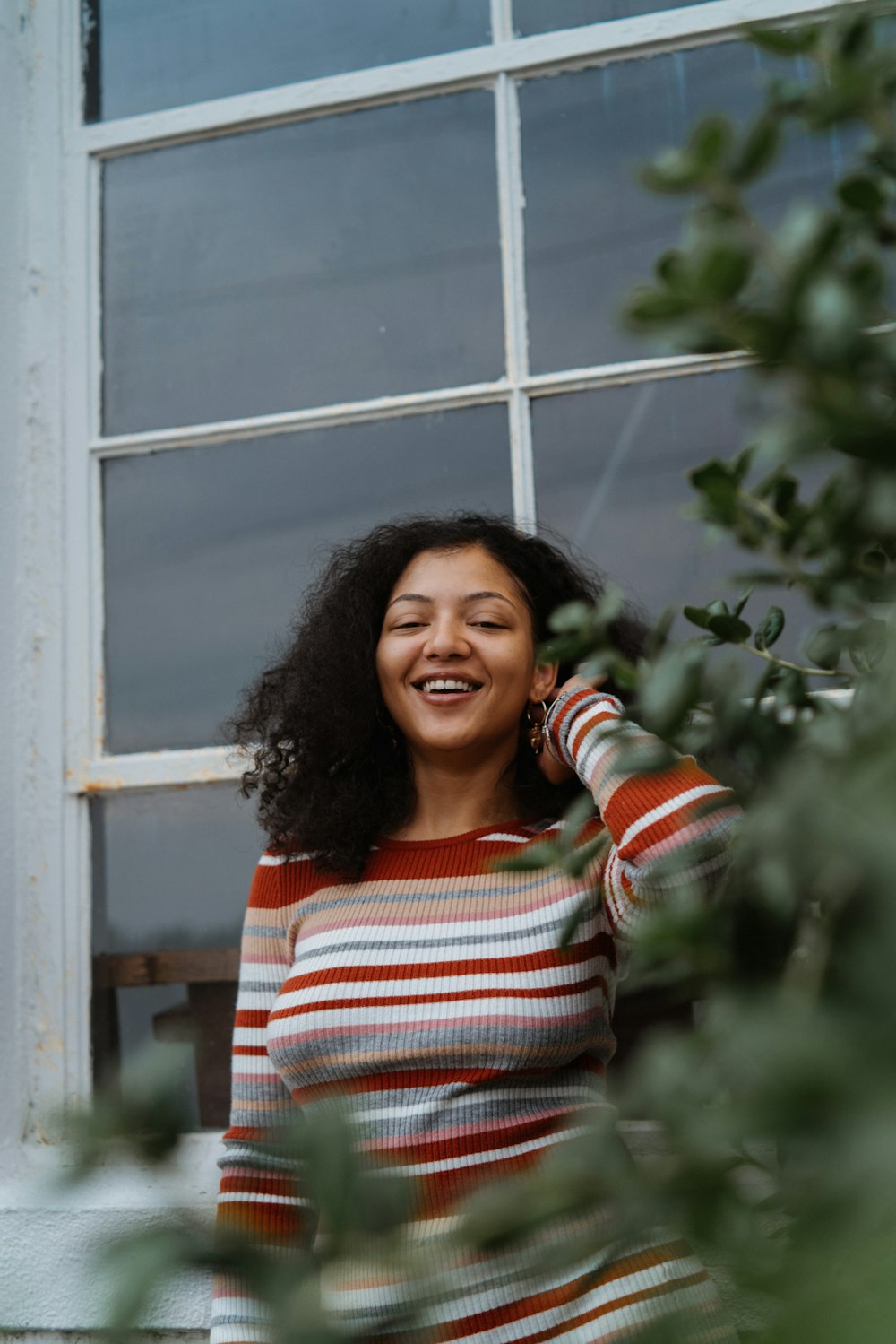 woman in red and white striped long sleeve shirt smiling