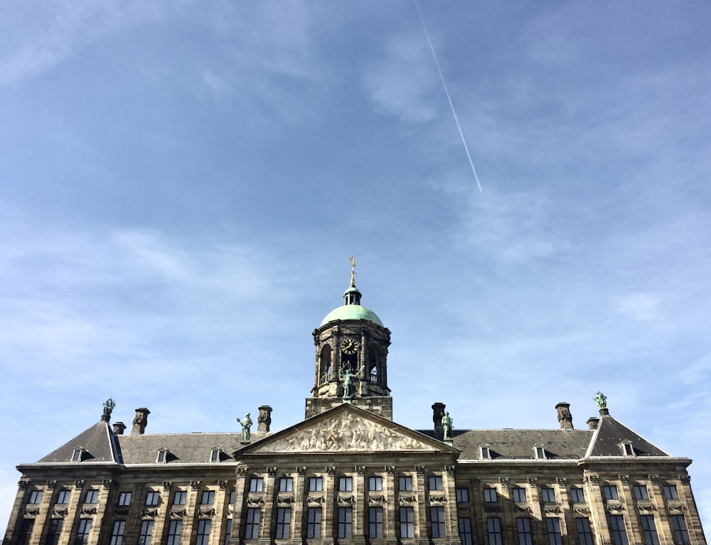 brown and gray concrete building under blue sky during daytime