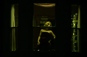 A stylish mannequin dressed in a flowing silk evening gown under warm lighting