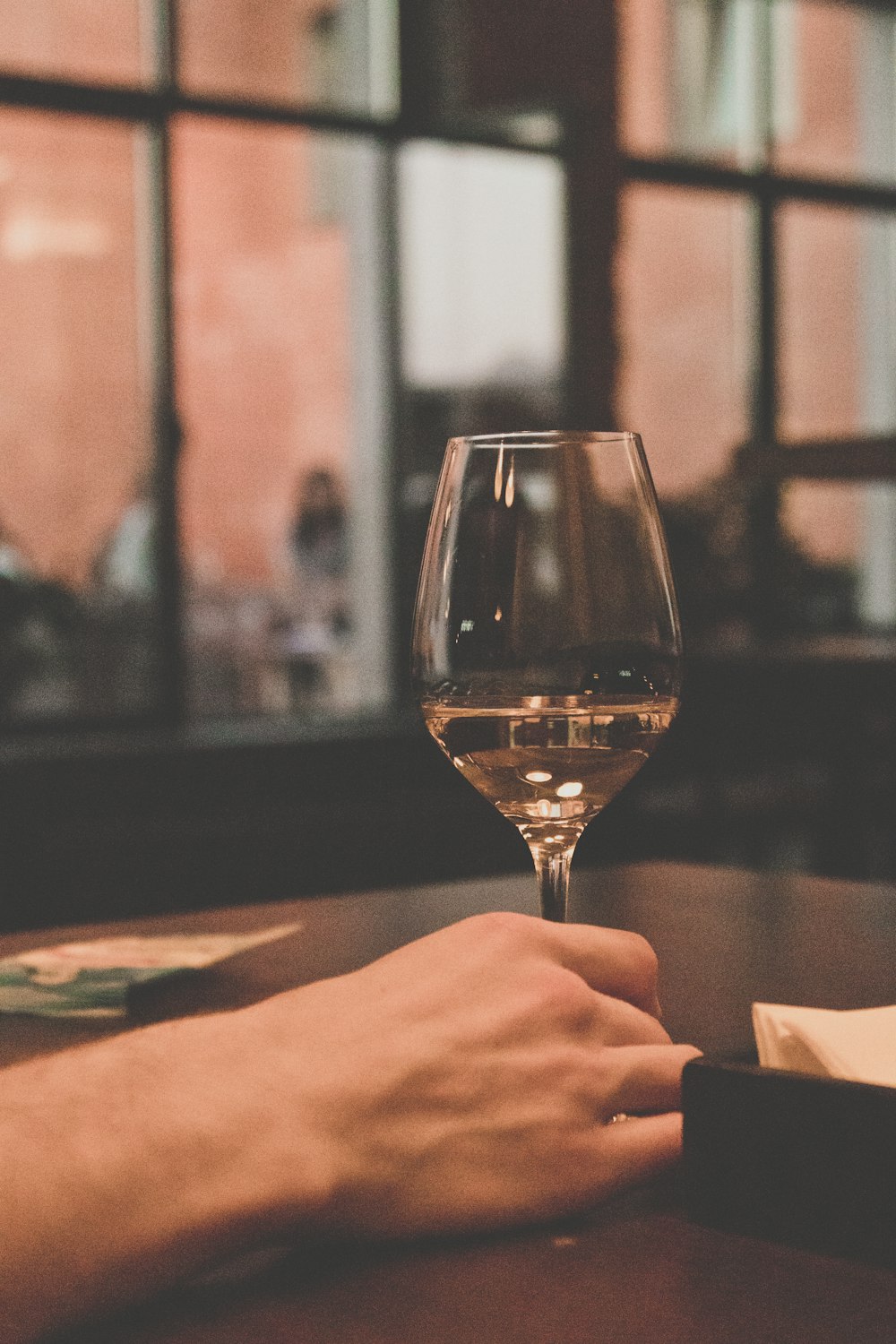 person holding clear wine glass