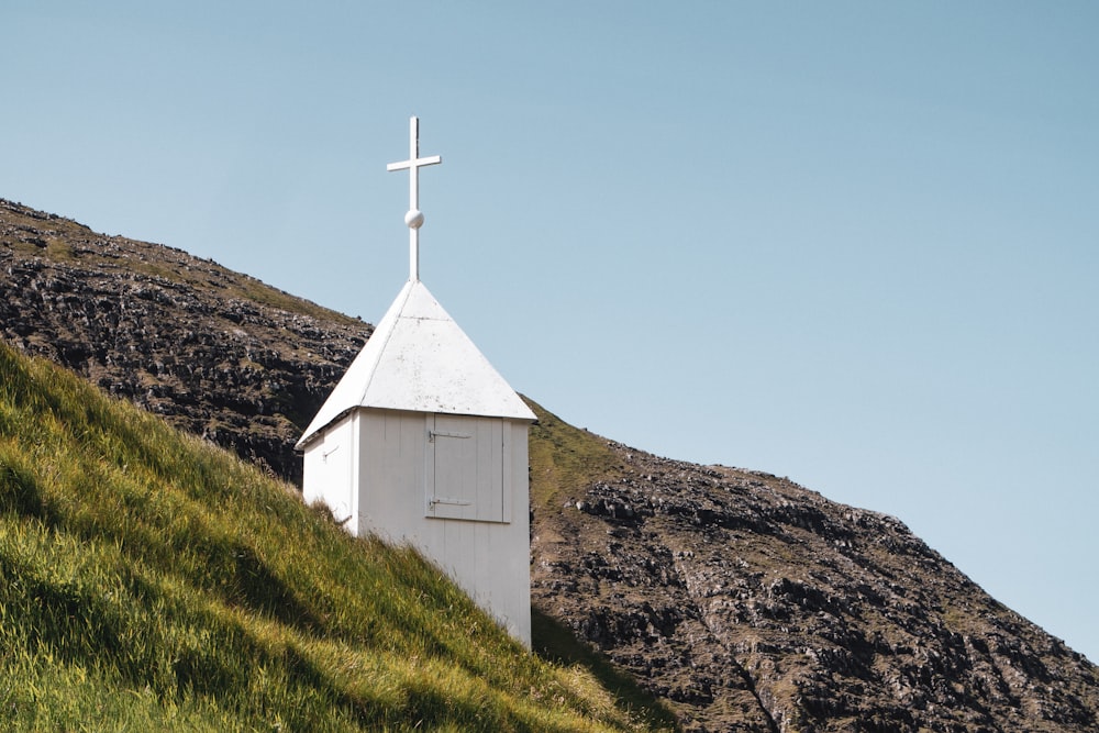 white church on green grass field under blue sky during daytime