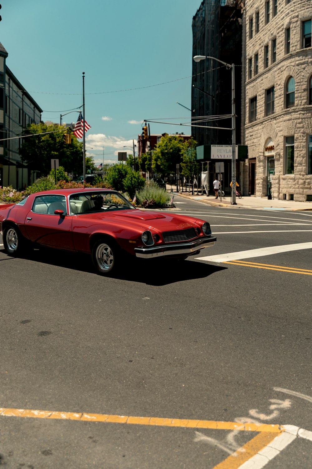 red coupe on road during daytime