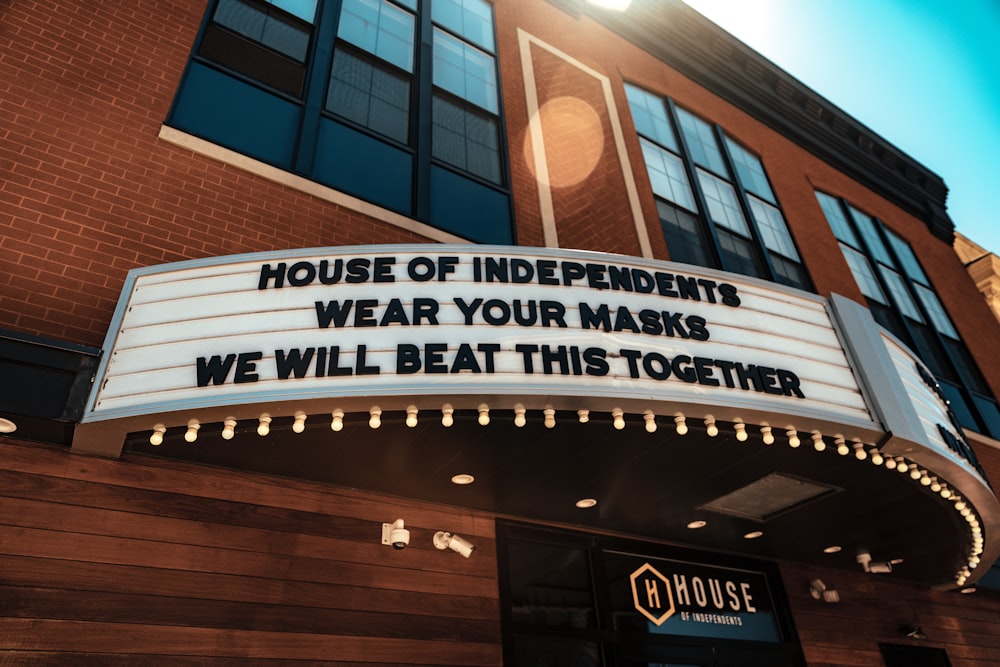 a theater marquee that says house of independents wear your masks we will