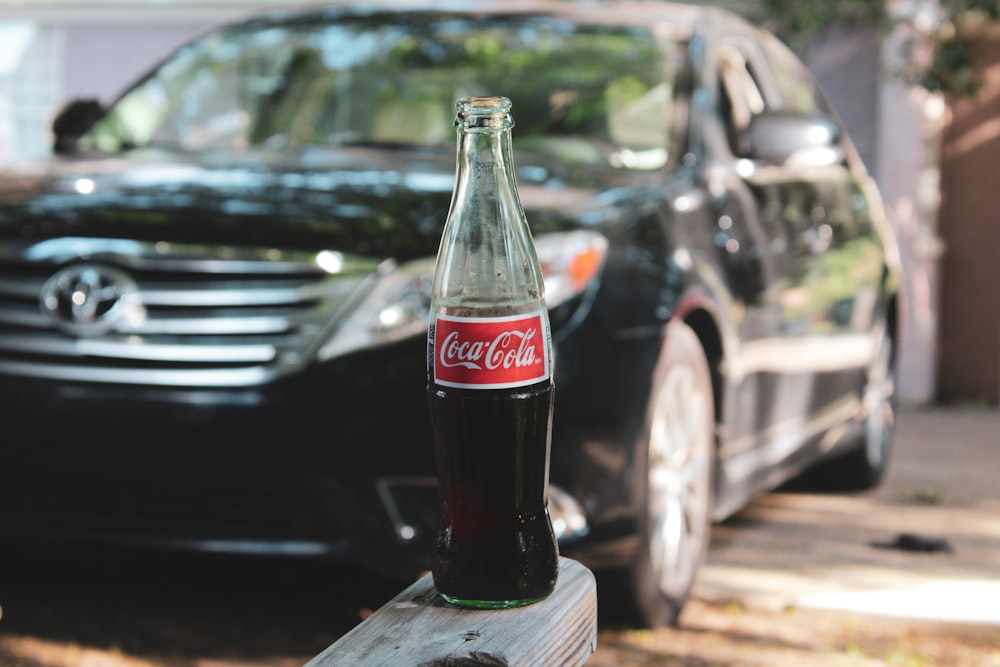 coca cola glass bottle on brown wooden table