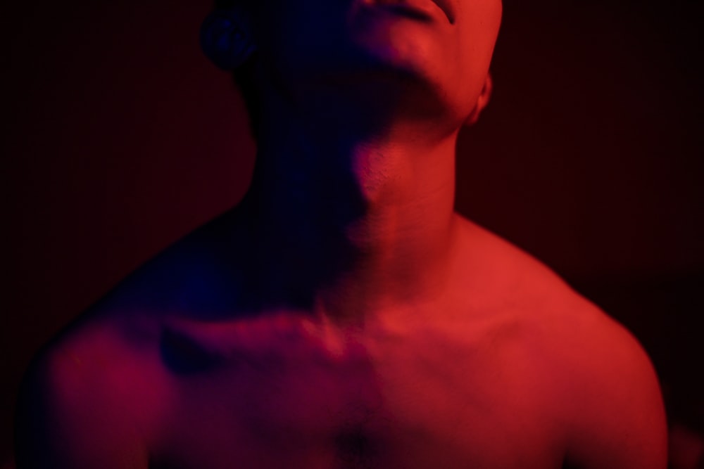 topless man with red light on his back