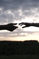 persons hand with heart shaped sign