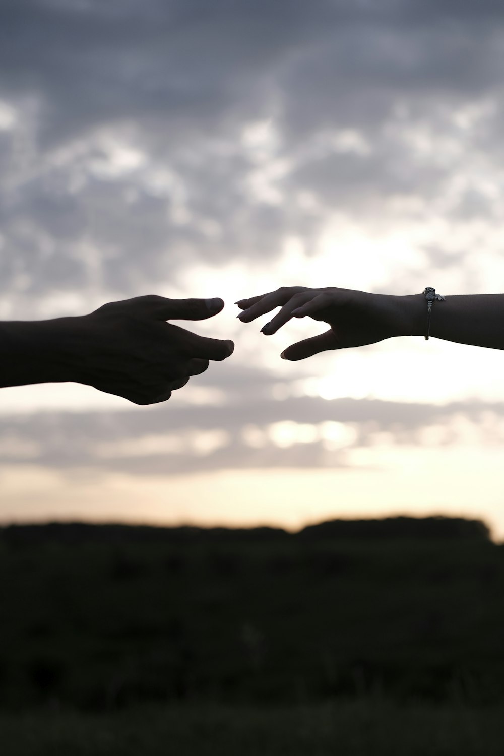 persons hand with heart shaped sign