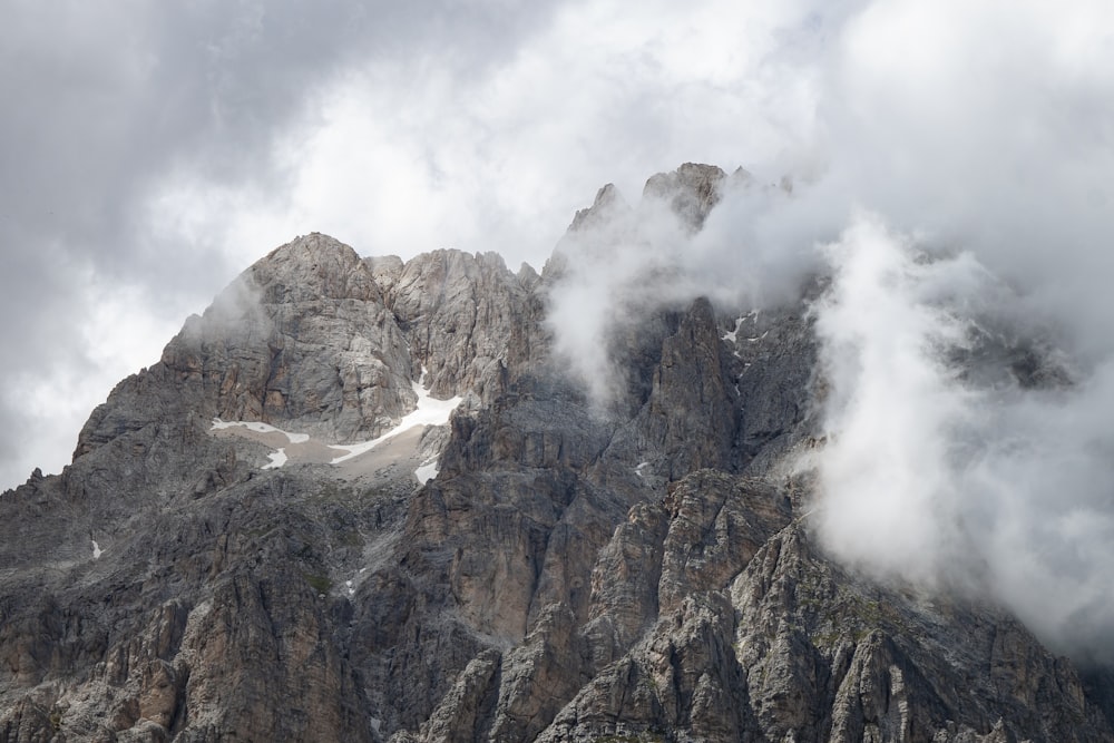 brown rocky mountain under white clouds during daytime