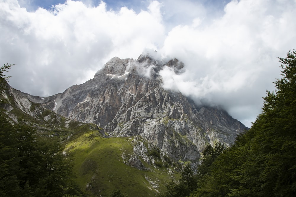 green and gray mountain under white clouds during daytime