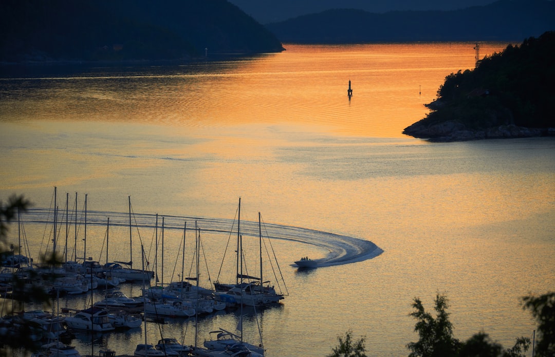 boat on sea near mountain during daytime