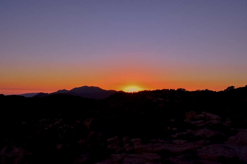 silhouette of mountain during sunset