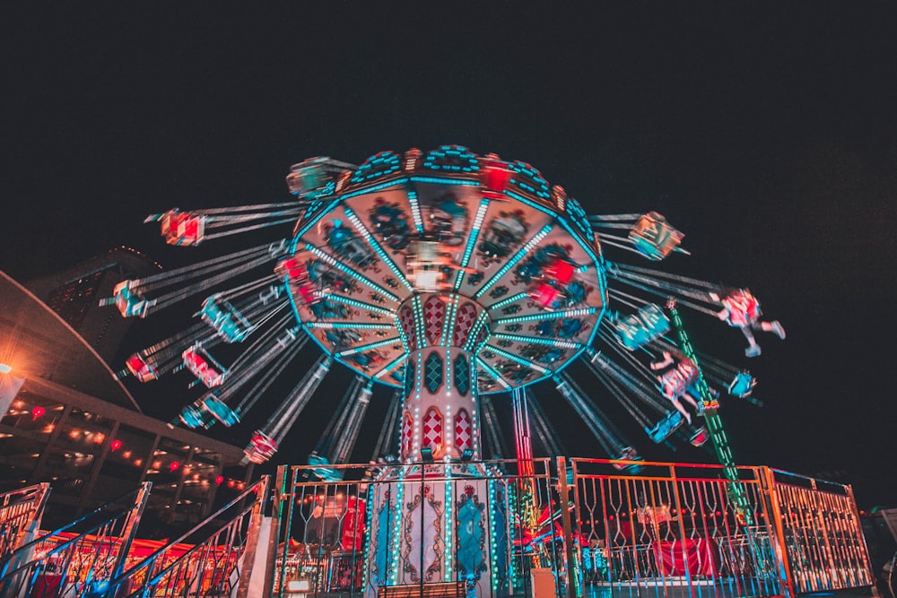 red and blue ferris wheel during night time