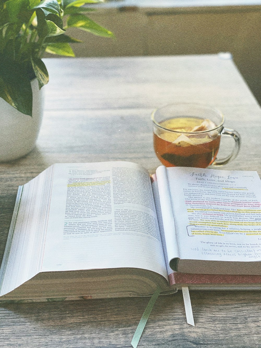 clear glass mug on white book page