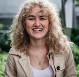 smiling woman in brown blazer