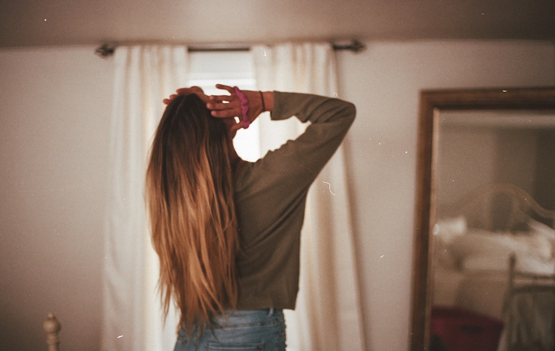 woman in gray long sleeve shirt and blue denim jeans,