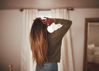 woman in gray long sleeve shirt and blue denim jeans